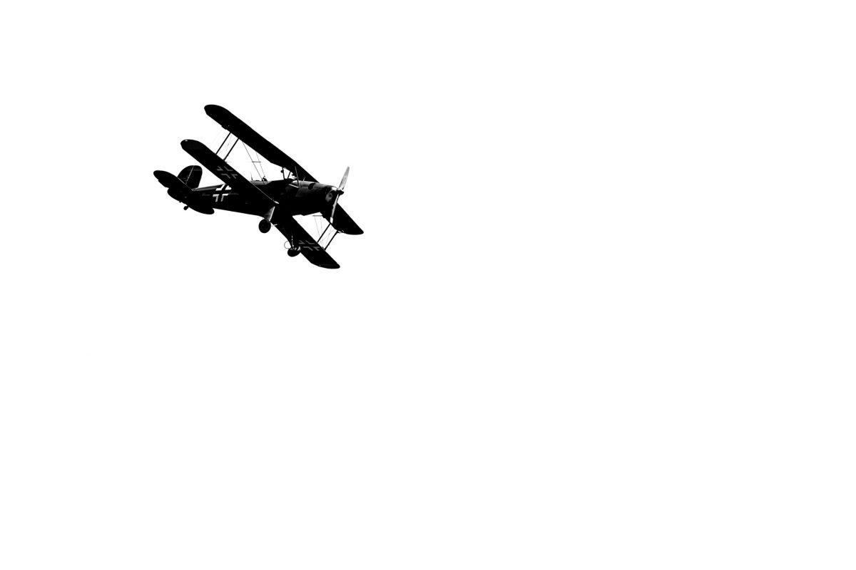 Low angle view of german biplane flying against sky