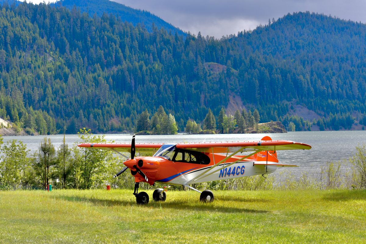 CubCrafters Orange NX Airplane in mountains